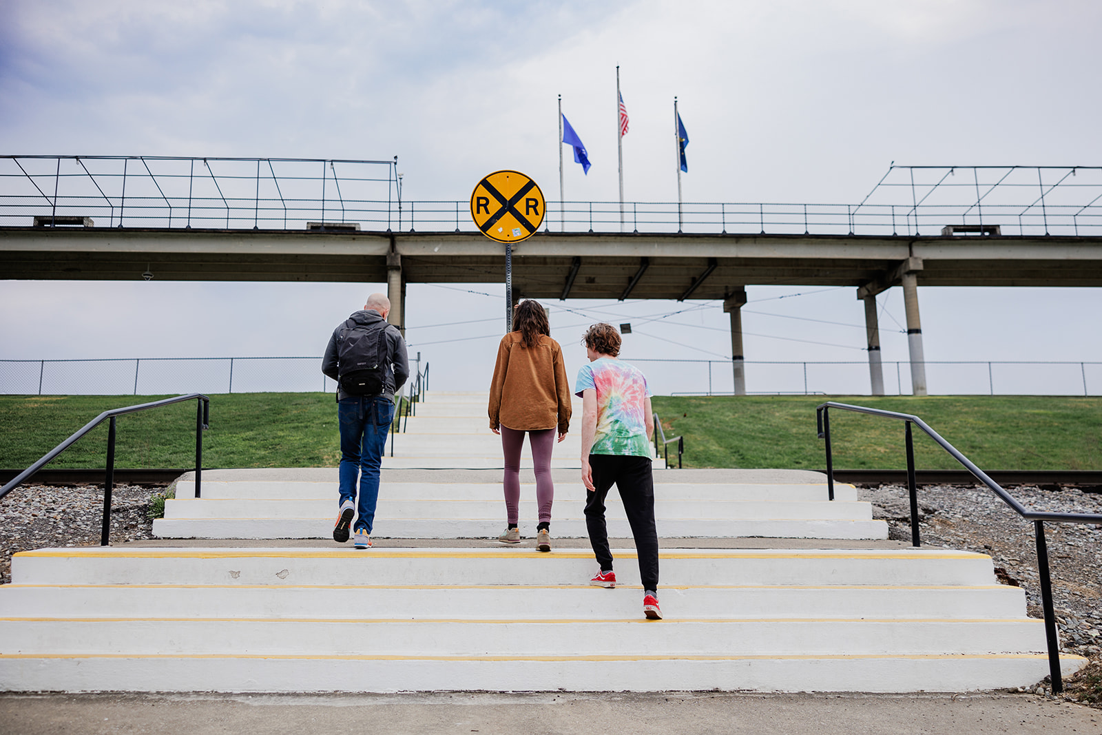 Group coaching- Allen walking with small group us concrete stairs.